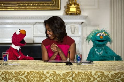 First Lady Michelle Obama With Sesame Street Muppets Elmo And Rosita
