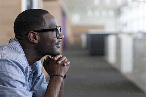 Man With Hand On Chin Side View Stock Photo