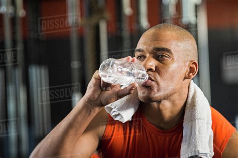 Black Man Drinking Water In Gym Stock Photo Dissolve