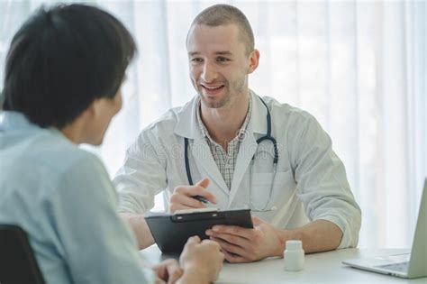 Doctor Listening Patient Explain His Symptom And Notes To Medical Record Stock Image Image Of