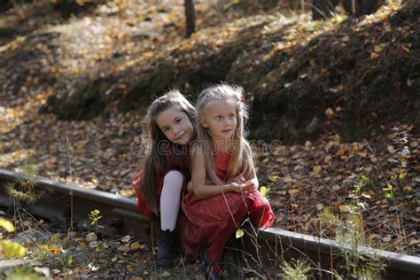 Two Little Cute Girls On Lawn In The Park Stock Photo Image Of Child