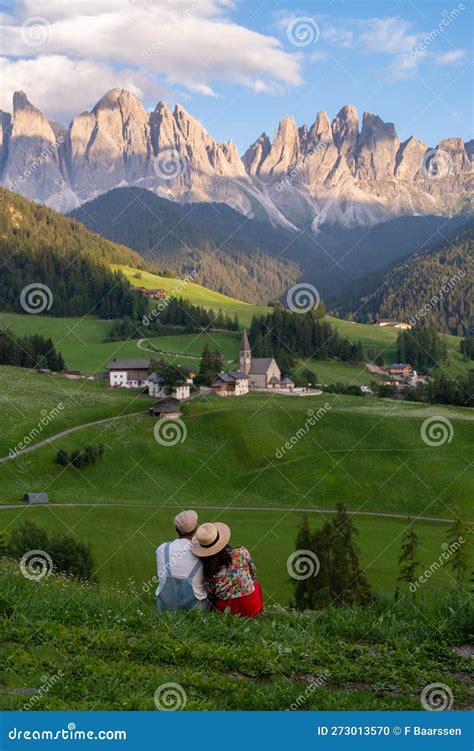 Couple Viewing The Landscape Of Santa Maddalena Village In Dolomites