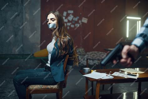 Premium Photo Maniac Kidnapper With A Gun Scared Female Victim On