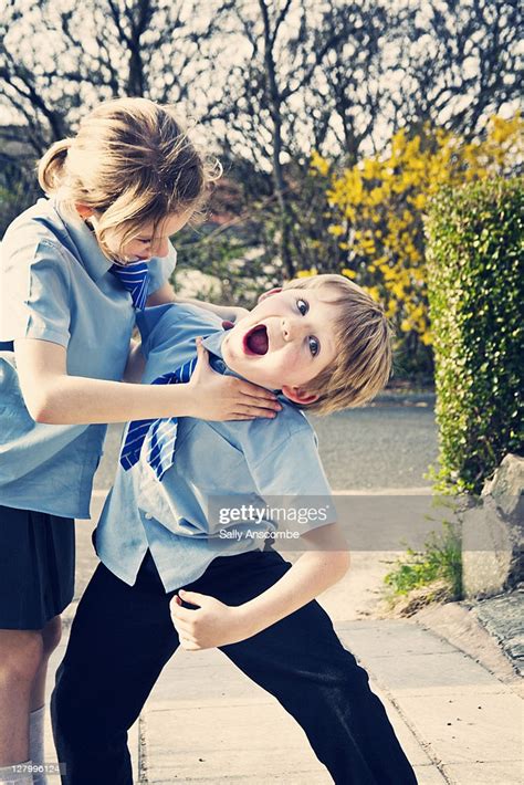 Two School Children Playing Fighting Outside High Res