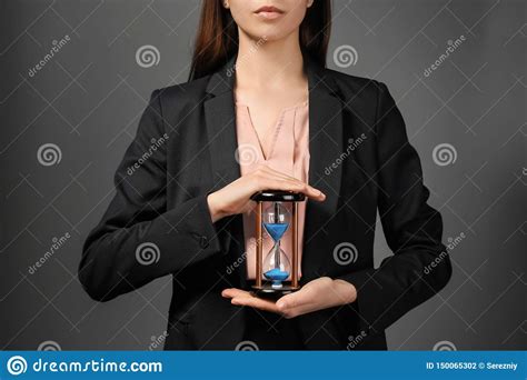 Woman Holding Hourglass On Dark Background Time Management Concept