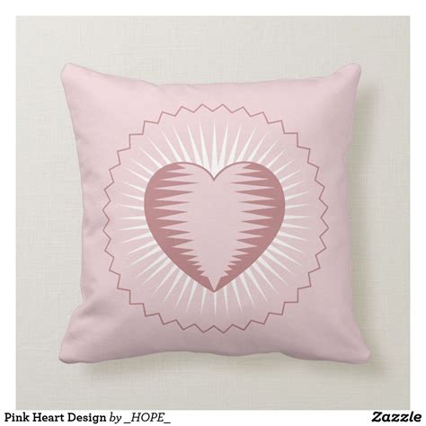 A Pink Heart Design On A Light Pink Pillow With Sunburst In The Middle
