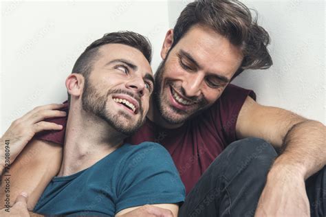 Happy Gay Couple Embraced Joking And Having Fun In An Intimate Hug