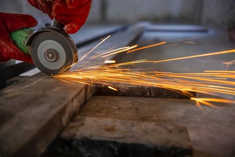 Worker Cutting Steel Rectangular Pipe In Construction Site Stock Photo