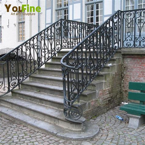 Smiling business woman standing on stairs at office building and holding h. Wrought Iron Outdoor Stair Railings | Tyres2c