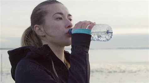 Young Healthy Caucasian Woman Training Hard Outside Drinking Water