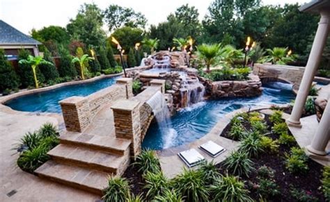 An Outdoor Swimming Pool Surrounded By Landscaping And Greenery With