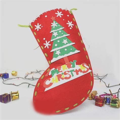 A Red Christmas Stocking Sitting On Top Of A White Table Next To Small