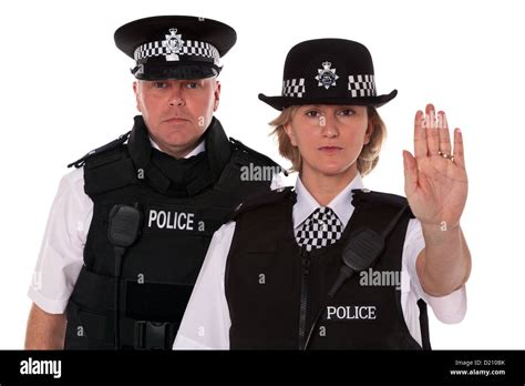 Studio Shot Of Male And Female British Police Officers In Uniform Stock