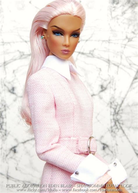A Barbie Doll Wearing A Pink Coat And White Shirt With Her Hands On Her