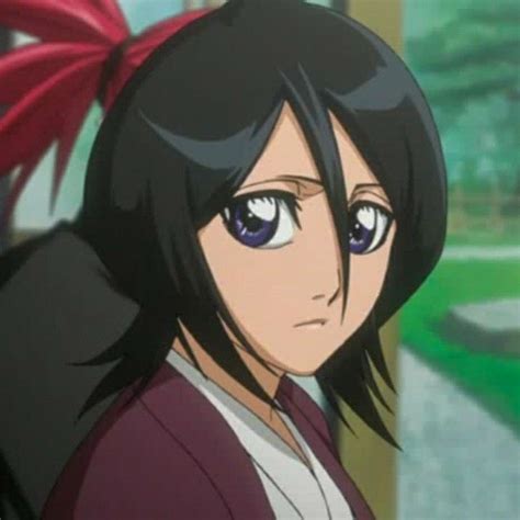 An Anime Character With Black Hair And Blue Eyes Looks At The Camera
