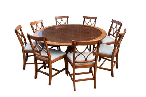 The bench features the same design as the dining table, creating a seamless look throughout the entire set. 20th Century George III Style Circular Dining Table and 8 Dining Chairs For Sale at 1stdibs