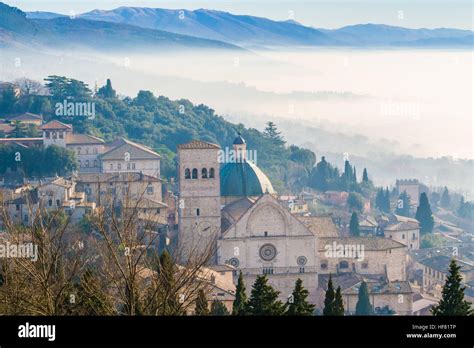 assisi in the fog and the cathedral of san rufino perugia province umbria region italy stock