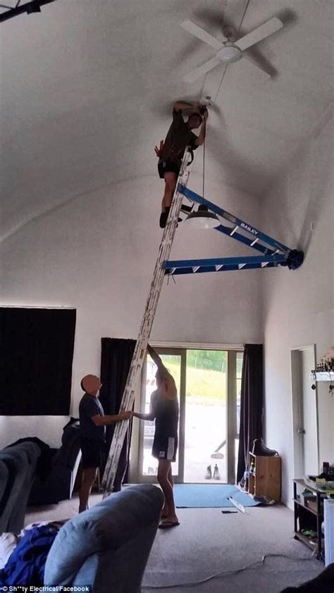 Australian Men Use Two Ladders To Change A Light Bulb Daily Mail Online