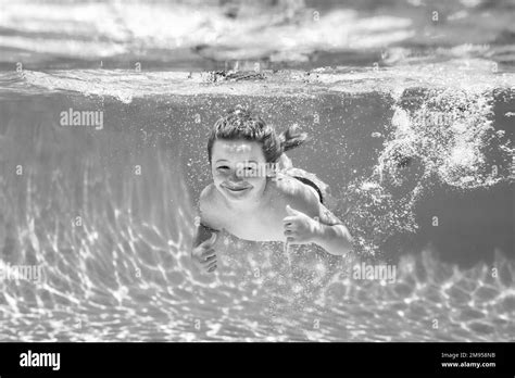 Boy Kid Swim And Dive Underwater Under Water Portrait In Swim Pool