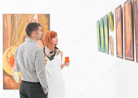 People Looking At Art Gallery Paintings — Stock Photo © Shotsstudio 32388961