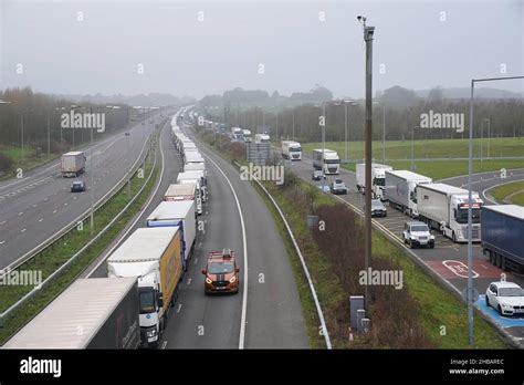 Freight Lorries Queuing On The M20 Motorway In Kent Heading To Dover Left And At The Entrance