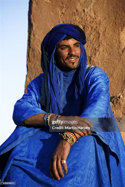 Tuareg Man Dressed In Traditional Clothing With Ait Benhaddou Kasbah In