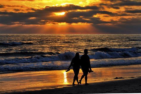 a couple walks on the beach at sunset in oceanside august 11 2013 by rich cruse on 500px