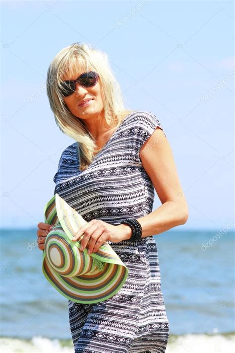 Mature Woman On Beach Summer Holiday Stock Photo By Voyagerix 27127095