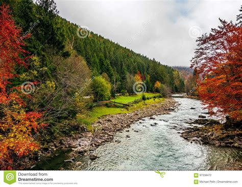 Picturesque Autumn Scenery With Forest River In Mountains Stock Photo