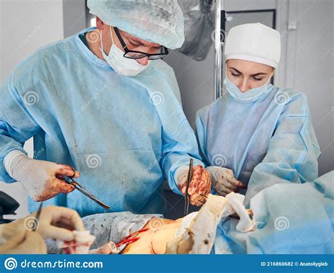 Surgical Team Conducting Abdominoplasty Surgery In Operating Room
