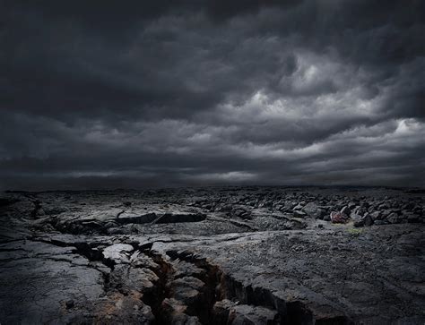 Storm Clouds Over Dry Rocky Landscape By Chris Clor