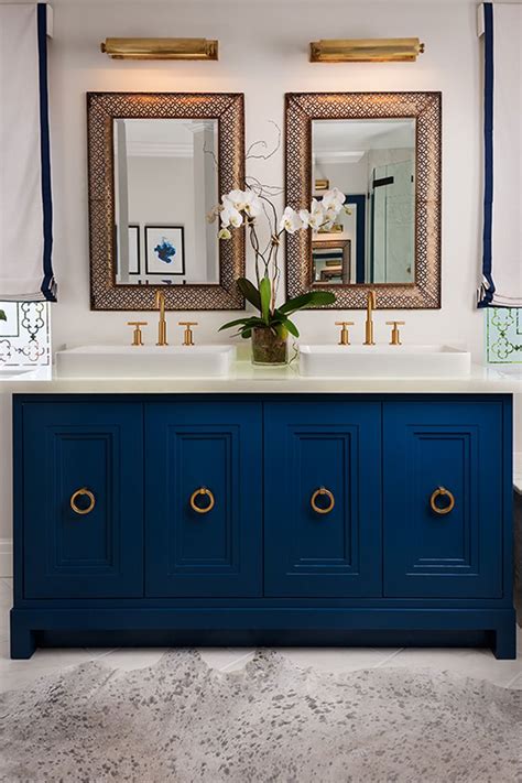 A navy blue vanity with a white sink basin and gold fixtures.need i say more? midnight blue his & hers bathroom sink | lovelyspaces.com ...