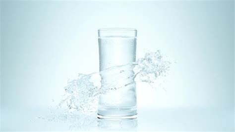 Pure Water Pouring Flow To Drinking Glass On Clear Background And