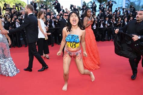 At The Premiere Of Cannes 2022 A Topless Protestor Shatters The Red Carpet