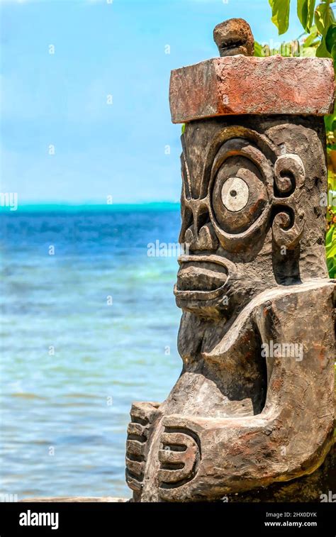 Traditional Tiki Statue In Front Of A Beautiful Palm Lagoon On Bora
