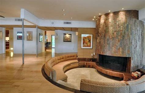 Curved Modern Sunken Living Room With Circular Slate Fireplace And