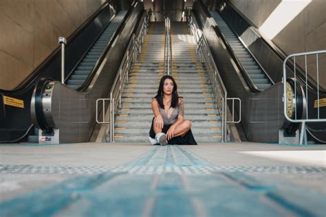 Free Photo Of Woman Sitting On The Ground With Gray Concrete Stairs