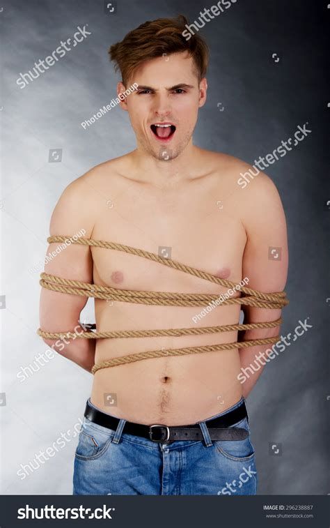 Tortured Shirtless Man Tied With A Rope Stock Photo