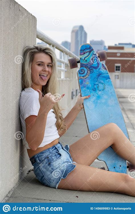 Gorgeous Young Coed Model Enjoying The Warm Weather With Her Skateboard