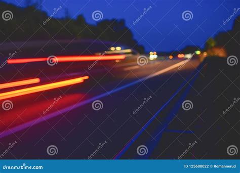 Highway At Twilight With Light Trails High Traffic Road With