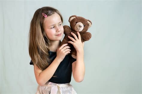 Premium Photo Pretty Child Girl Playing With Her Teddy Bear Toy