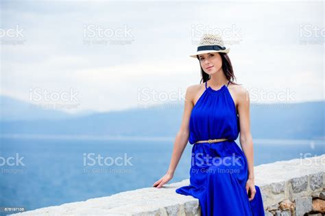Photo Of Beautiful Young Woman Sitting On The Stairs In Greece Stock