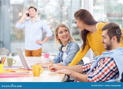 Cheerful Young Colleagues Are Discussing New Stock Image Image Of