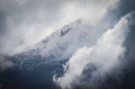 Fog Rolls In Over Snowy Mountains During Winter In Lone Peak Parkway