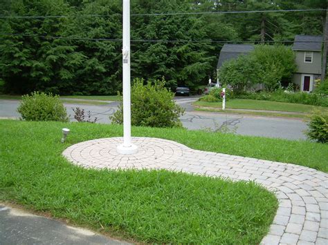 Finally, some people incorporate stepping stones into their flagpole landscape design. brick wail to flag pole | Cheap landscaping ideas, Modern ...