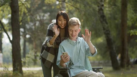 Being In The Public Park In A Good Weather A Young Sweet Couple Decide