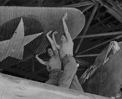 female us marines unfolding the wing of an aircraft naval air technical training center norman