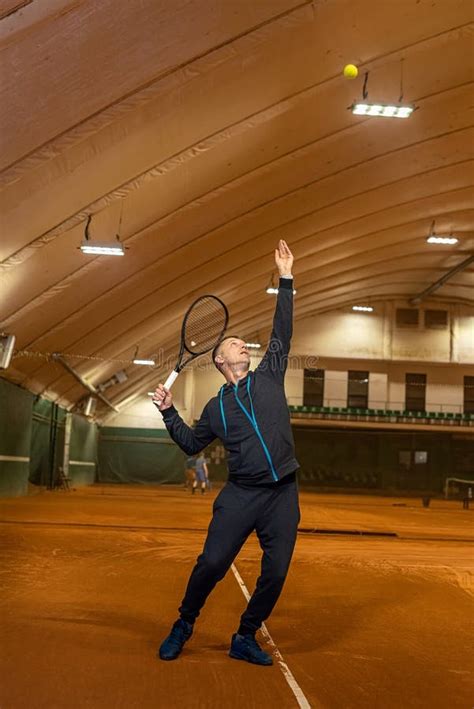 Portrait Of A Male Tennis Player Hitting A Tennis Ball During Training