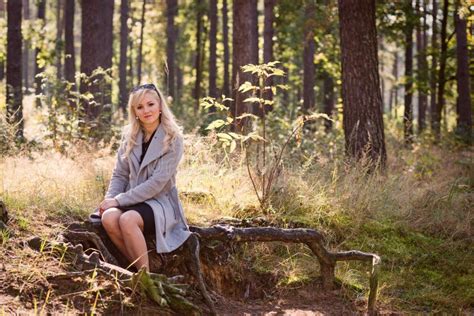 A Young Blonde Woman Walking Through The Forest On A Sunny Autumn Day Stock Image Image Of