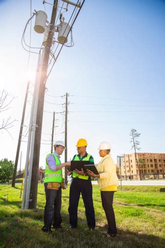 Construction Utilities Workers Supervisors Talk At Job Site Stock Photo